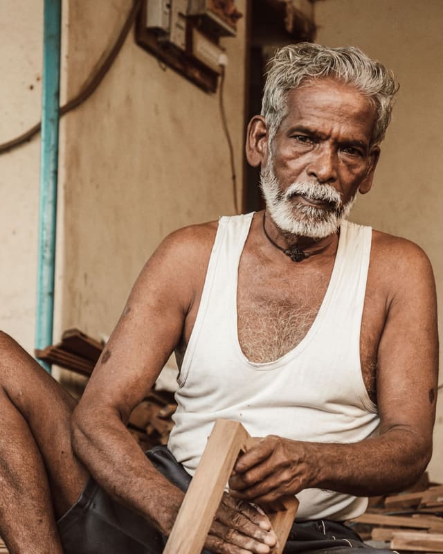 A senior carpenter at work in his workshop
